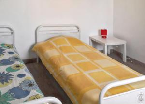 a small room with two beds and a table at Appartement lumineux dans le centre de Digne-les-Bains avec balcon. in Digne-les-Bains
