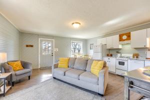 a living room with a couch and a kitchen at Bass Fishing Paradise Cottage on Table Rock Lake in Cape Fair +25 photos