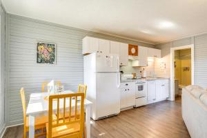 a kitchen with a table and a white refrigerator at Bass Fishing Paradise Cottage on Table Rock Lake in Cape Fair