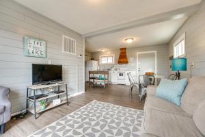 a living room with a couch and a flat screen tv at Lake and Trail Access Cape Fair Cottage with Deck in Cape Fair