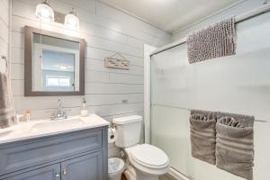 a bathroom with a toilet and a sink and a mirror at Lake and Trail Access Cape Fair Cottage with Deck in Cape Fair +28 photos