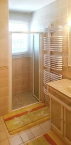 a bathroom with a shower with a glass door at Maison chaleureuse à Nages avec vue sur lac et montagne in Nages +11 photos