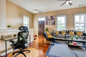 a living room with a couch and a table at Free Early Check-In or Late Check-Out - 5 mins to DT & Forsyth - Mini Gym in Savannah