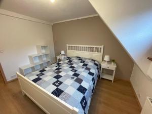 a bedroom with a checkered bed and two night stands at Ferienhaus Groß Grönau in Groß Grönau