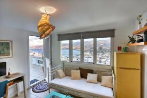 a living room with a couch in front of a window at Terrace house in Sitia