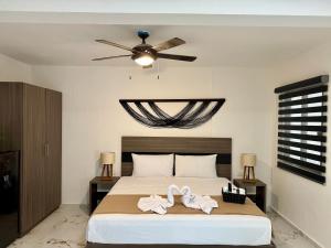 a bedroom with a bed with a ceiling fan at CASA TORTUGA 5Th Ave in Playa del Carmen