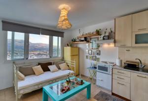a kitchen with a couch and a table in a room at Terrace house in Sitia