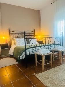 a bedroom with a bed and a bench in it at Una casa en el lago in Arcos de la Frontera