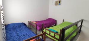 a room with two bunk beds and a fan at Deptos a cuadras del corsodromo in Gualeguay