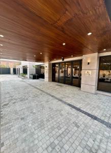 an empty lobby of a building with a wooden ceiling at Lahore Grande Boutique Hotel in Lahore