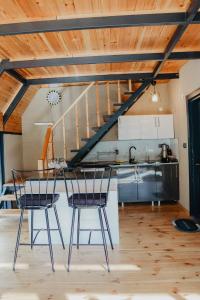 a kitchen with a table and chairs in a loft at Tina Bungalov in Sapanca