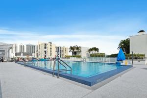 a large swimming pool in a resort with buildings at Hollywood Studios Condo Costa in Hollywood