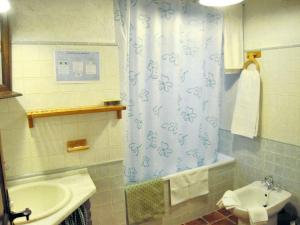 a bathroom with a sink and a shower curtain at Spacious House in Hornos with Mountain View in Hornos +24 photos