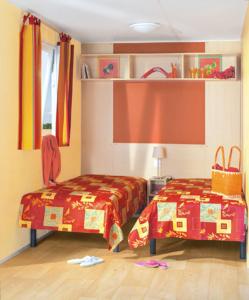 ein Schlafzimmer mit zwei Betten und einer Lampe in der Unterkunft Charmant Bungalow à Juncalas avec Terrasse et Vue Montagne in Juncalas