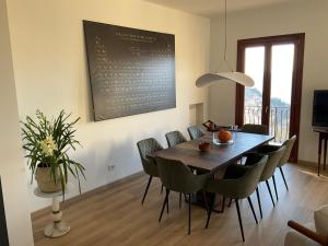 a dining room with a table and chairs at Villa Perla del Sole in Baiardo