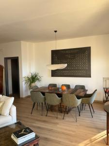 a living room with a dining room table and chairs at Villa Perla del Sole in Baiardo