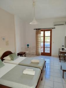 A bed or beds in a room at Relax on Santorini