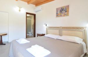a bedroom with a bed with two towels on it at Villa Rossella in Gaggi