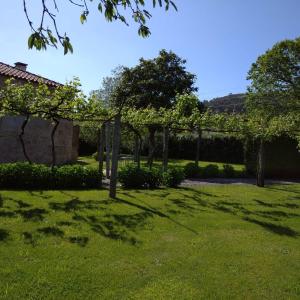 een tuin met bomen en een hek in het gras bij Casas da Quinta da Cancela in Balugães +37 foto's