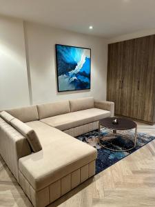 a living room with a couch and a table at Lahore Grande Boutique Hotel in Lahore