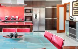 a kitchen with a glass table and red appliances at Spacious villa in Santo Tirso with private pool 850 m² and jacuzzi in Santo Tirso