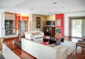 a living room with a white couch and a table at Spacious villa in Santo Tirso with private pool 850 m² and jacuzzi in Santo Tirso