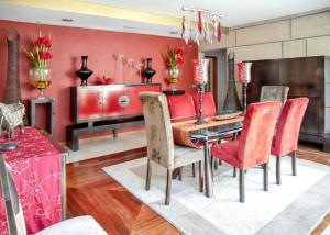 a dining room with red walls and a table and chairs at Spacious villa in Santo Tirso with private pool 850 m² and jacuzzi in Santo Tirso