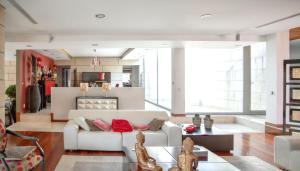 a living room with a white couch and a table at Spacious villa in Santo Tirso with private pool 850 m² and jacuzzi in Santo Tirso +48 photos