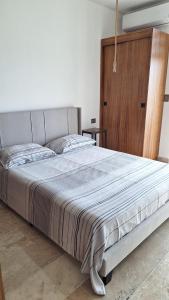 a bedroom with a large bed with a wooden cabinet at Playa del Carmen - Playaquerida in Playa del Carmen +76 photos