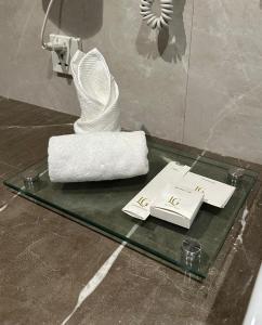 a glass table with a white sculpture on top of it at Lahore Grande Boutique Hotel in Lahore