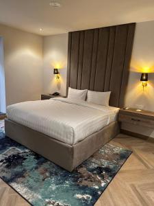 a bedroom with a large bed and two night stands at Lahore Grande Boutique Hotel in Lahore +18 photos