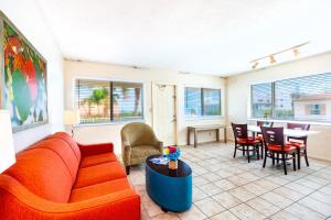ein Wohnzimmer mit Sofa und Tisch in der Unterkunft Enchanted Isle Hollywood Beach Resort in Hollywood