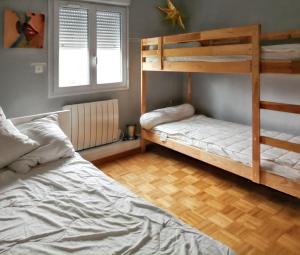 a bedroom with two bunk beds and a wooden floor at Villa élégante à Château-la-Vallière avec piscine privée in Château-la-Vallière +29 photos
