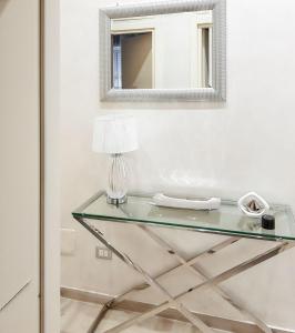a glass table with a lamp and a mirror at Charming Villa in Fontane Bianche with Private Pool in Fontane Bianche +30 photos