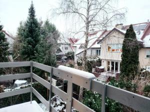 a house with a white fence in the snow at Pod Czaplą in Warsaw