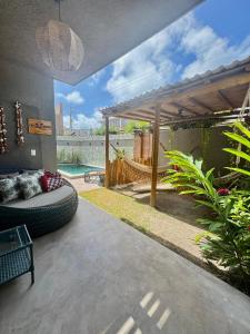 a patio with a hammock and a swimming pool at Seaesta Milagres in São Miguel dos Milagres