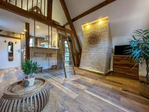 a living room with a staircase and a brick wall at Le Temps des Rêves in Chartres