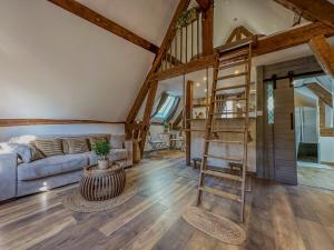 a living room with a staircase and a couch at Le Temps des Rêves in Chartres