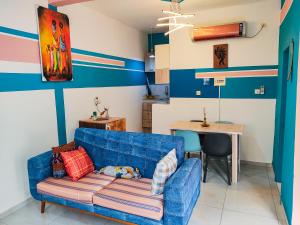a living room with a blue couch and a table at MOOKSQUARE GJ SPOT in Douala