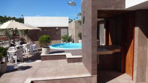 a house with a swimming pool and a patio at Ancoradouro Hotel - Centro De Porto Seguro in Porto Seguro