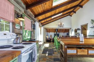 a kitchen with a stove and a counter top at Cabin at the Forest Edge in Packwood +35 photos