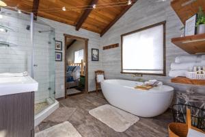 a bathroom with a large tub and a sink at Cabin at the Forest Edge in Packwood