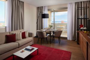 a living room with a couch and a table at NH Alicante in Alicante