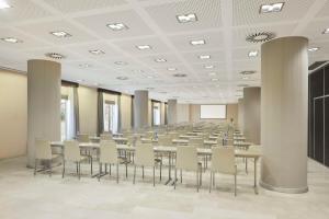a large room with tables and chairs in it at NH Alicante in Alicante