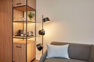 a living room with a couch and a book shelf at NH Alicante in Alicante