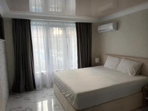 una camera da letto con un letto e una grande finestra di Apartament Milenium a Pomorie Altre 12 foto