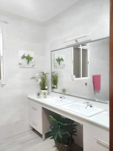 a white bathroom with a sink and a mirror at Charming chalet in Prado del Rey with private pool in Prado del Rey