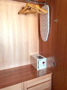 a microwave sitting on top of a wooden counter at Charming Apartment in Estômbar with Private Pool. in Estômbar
