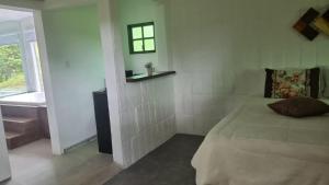 a bedroom with a bed and a sink and a window at Sitio Azeite com Pimenta in Itabirito +29 photos