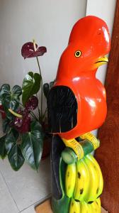 a statue of a bird standing on a bunch of bananas at Hospedaje Oxa Paraíso in Oxapampa +25 photos
